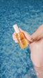 women holding bottle in pool